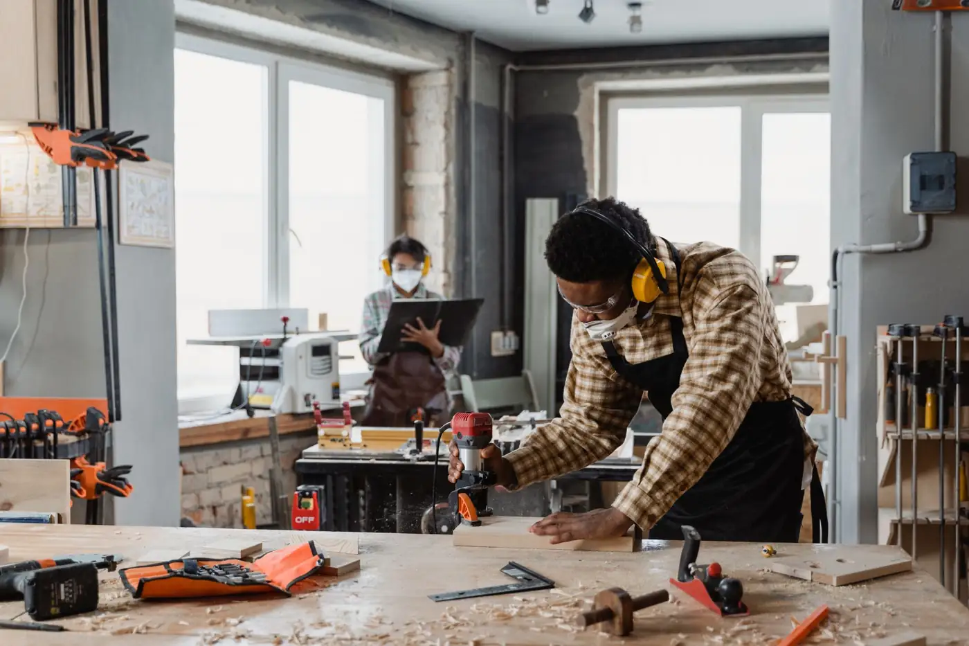 Craftsman shaping timber with a handheld router