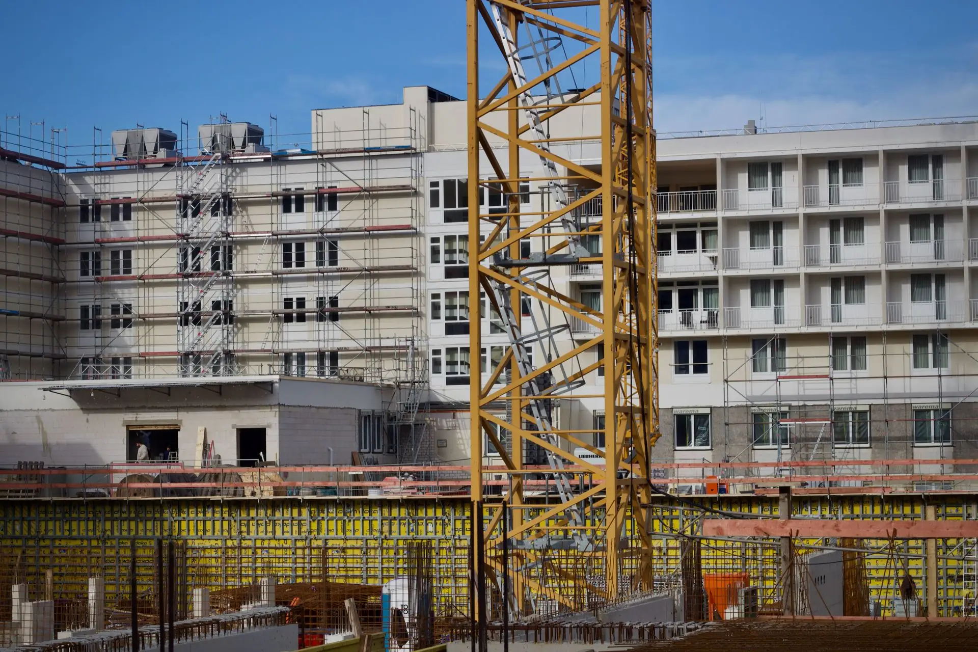 Urban construction site with tower crane