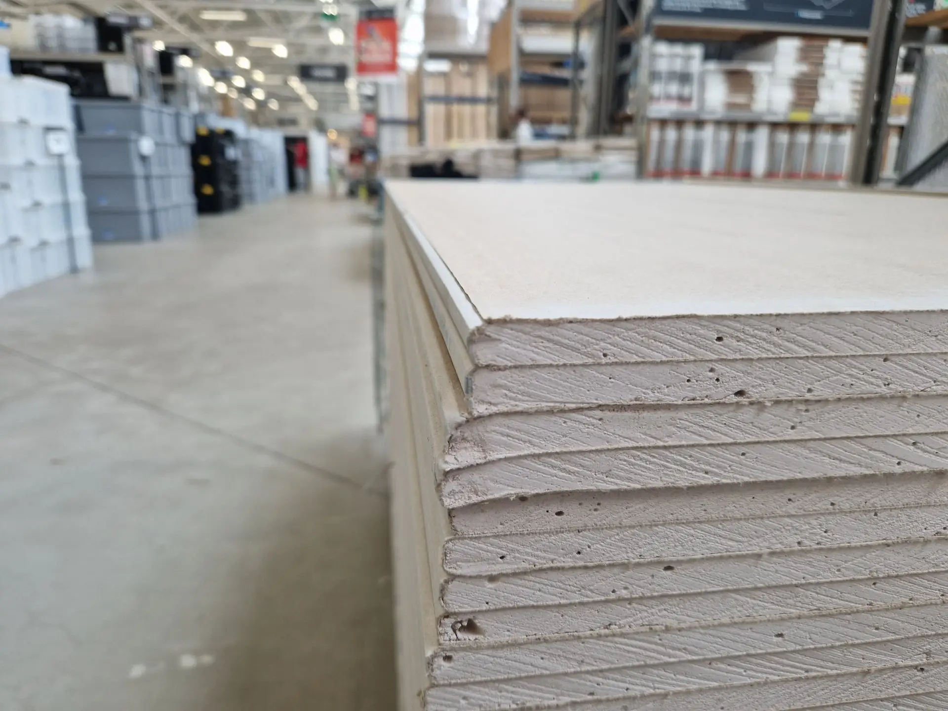 Stacked drywall sheets in a warehouse aisle