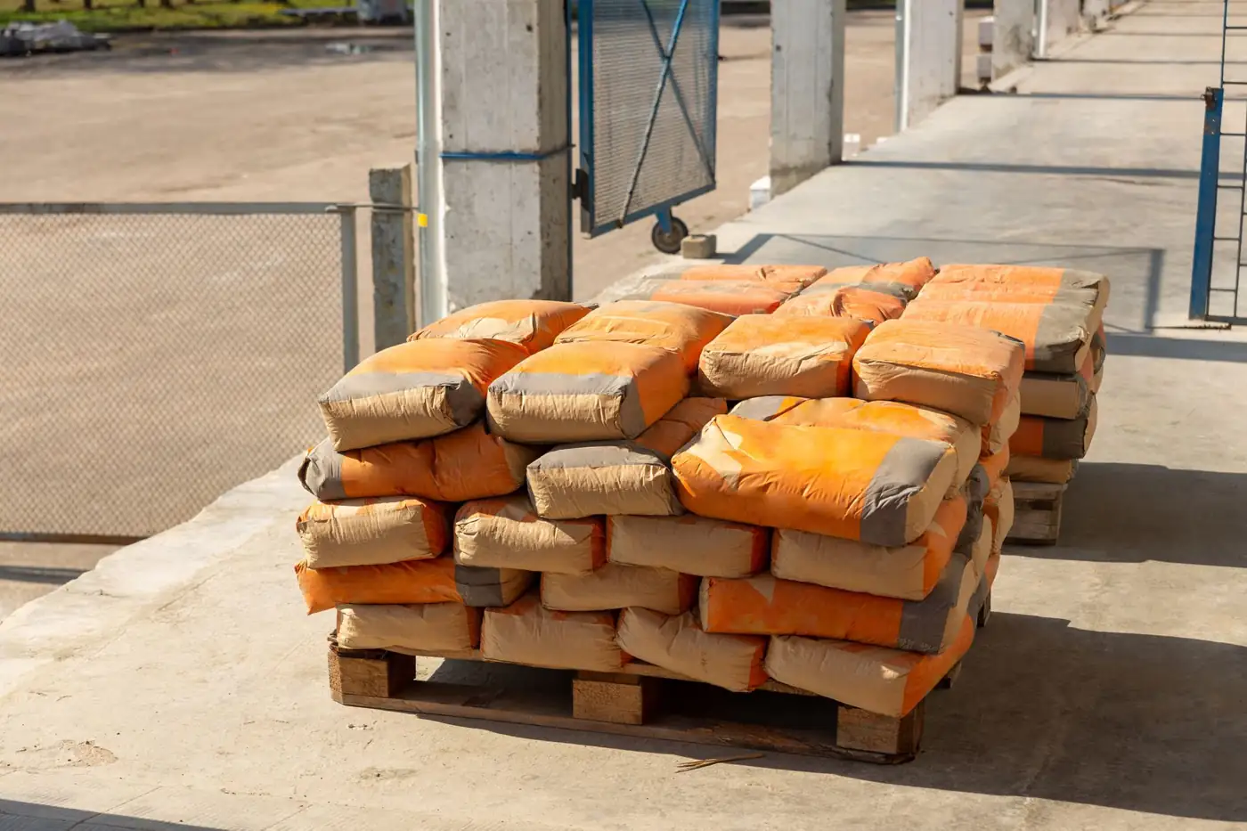 Pallet of bagged cement on a loading dock