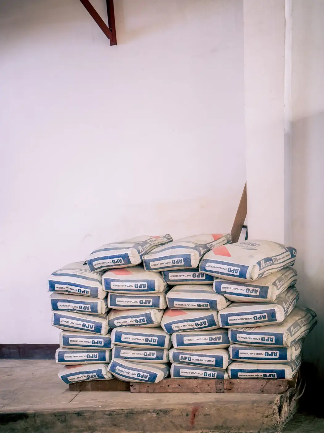 Pallet of APO Portland cement bags in a warehouse